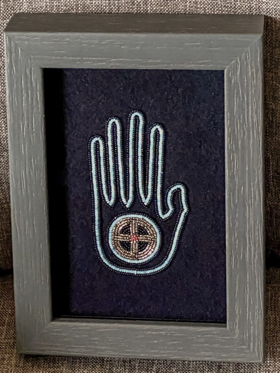 Framed two-point needle appliqué beadwork on wool